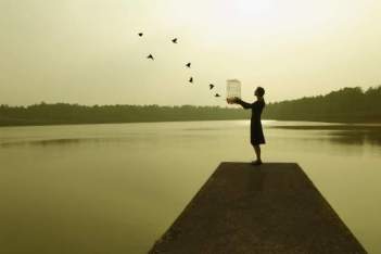 a women releases birds from her cage